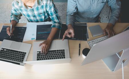 Developing programming and coding technologies working in a software engineers developing applications together in office.の写真素材