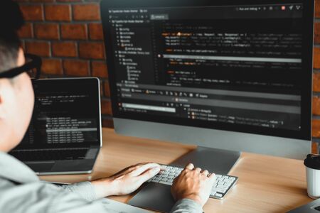 Asian man working code program developer computer web development working design software on desk in...