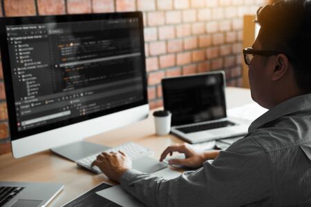 Asian man working code program developer computer web development working design software on desk in...