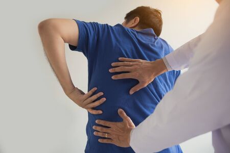 Patient is pointing to the point where the muscle pain is provided to the physical therapist to...