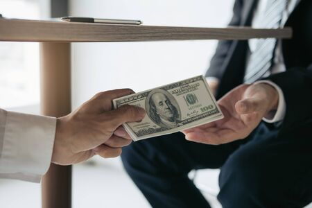 Entrepreneurs are receiving money under the desk that is a bribe of their partners with both of whom...