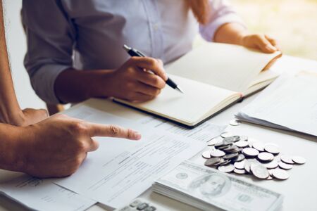 Two asian couples and men and women are together analyzing expenses or finances in deposit accounts and daily income sources with an savings economical concept.の写真素材