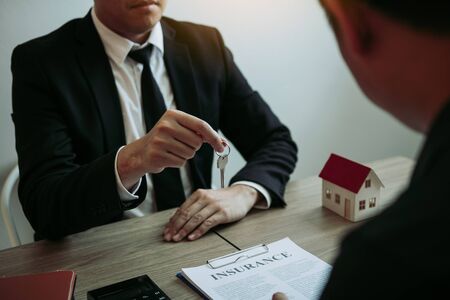 Home agents are handing out keys to home buyers who are signing contracts at the office.