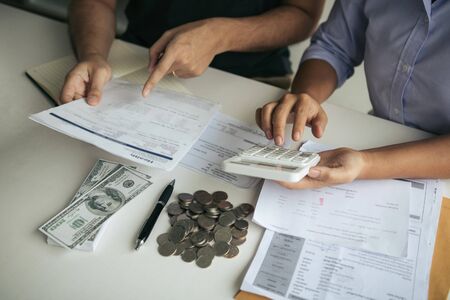Two asian couples and men and women are together analyzing expenses or finances in deposit accounts...