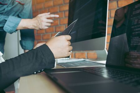 Professional development programmer cooperating meeting programming website working a software in office room.の写真素材
