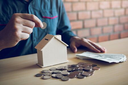 Men are putting coins together with the idea of collecting money to buy a new house.