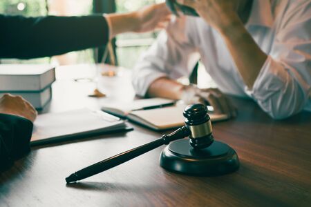 Lawyer is consoling the client in his counsel and will not escape the lawsuit.の写真素材