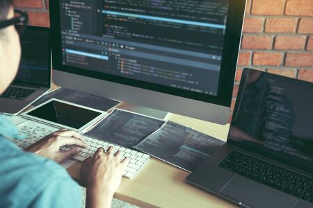 Asian man working code program developer computer web development working design software on desk in...