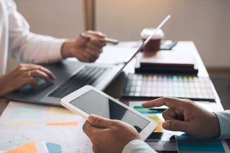 Business partnership pointing to the graph of the company financial statements report and profits...
