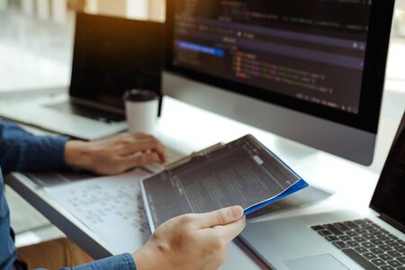 Asian man working code program developer computer web development working design software on desk in...