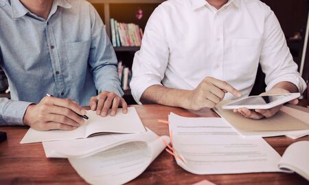 Student friends are using tablet searching for information about reading in class.の写真素材