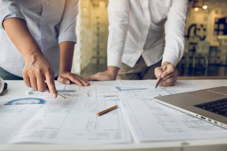 Engineers are helping to design work on blueprints and collaborate on structural analyzing of...