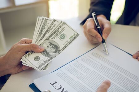 Employees are doing corruption by giving dirty money to signing contract.の写真素材