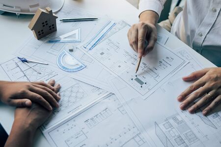 The partnership engineering man or co-workers working on a project and discussing together with...