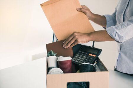 Woman employees are keeping their own items on the desk because they are about to go to resign with...