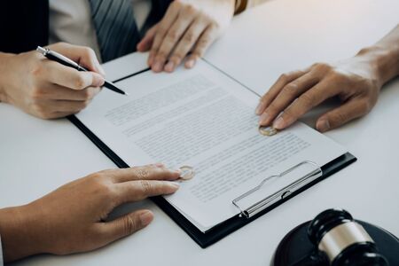 Couple is divorced who handed their engagement ring to the divorce documents that the lawyer was clarifying.の写真素材