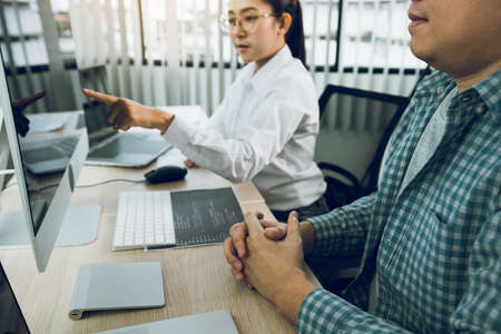 Two asian team working development of programming and encryption technology website design programmers on desk in office.の写真素材