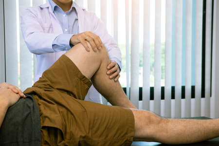 Physical therapists are using the handle to the patient knee to check for pain.