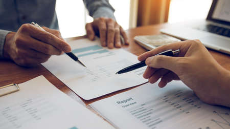 Managers are using tablets to analyze sales cost reports and explain summary reports to employees...