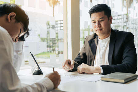 Male manager is talking or explaining about having to dismiss the employee while being handed out a...