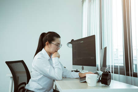 Asian female software developers are stressed in analyzing code-based systems.の写真素材