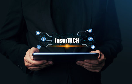 Insurance technology (Insurtech) concept, Hand of business man looking data information on tablet.の写真素材