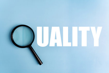 Inscription quality on magnifying glass word, blue background, business concept.