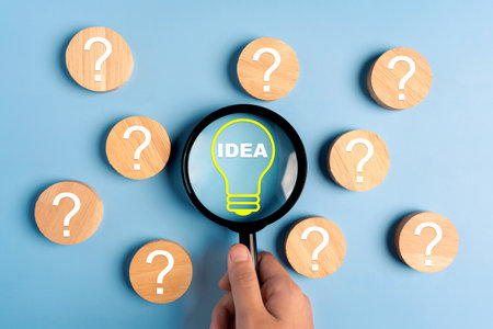 Magnifier focus light bulb illuminated and question icon, idea concept.の写真素材