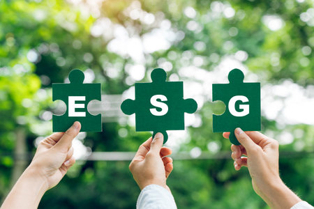 Hands of business team holding jigsaw, ESG Environmental, social and corporate governance concept.