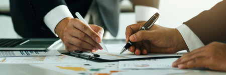 Two businessman team calculate about summary report annual on table office.の写真素材