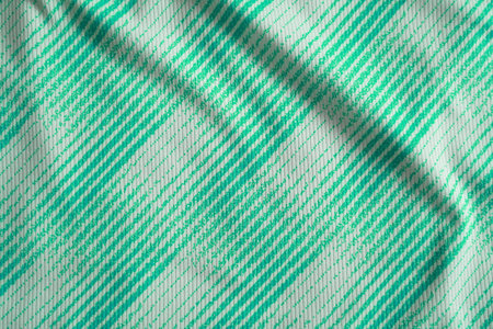 Close up of green football jersey sports clothing fabric texture.