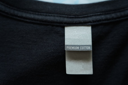 Close up of blank white clothing care label on shirt fabric background.の写真素材