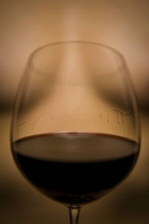 Wine Legs on a crystal glass with a nude in the background