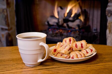 Coffee Strawberry Pastries in front of Fireplaceの写真素材