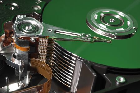 Opened and Exposed Hard Drive Platters in Greenの写真素材