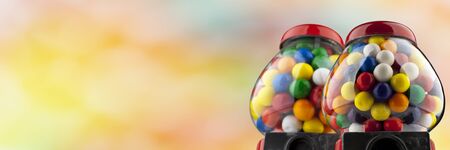 Coin Operated Gumball Machines isolated on colorful backgroundの写真素材