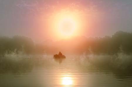 Fishing. A misty morning in a boat.の写真素材