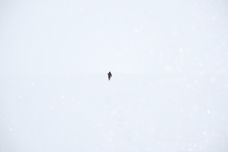 Fisherman out into the snowy expanse of the lake. Winter fishing.の写真素材