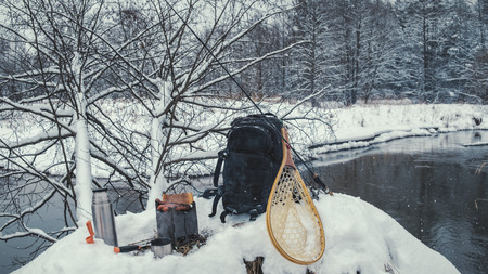 A picnic on a fishing trip, on a snow-covered winter river.の写真素材