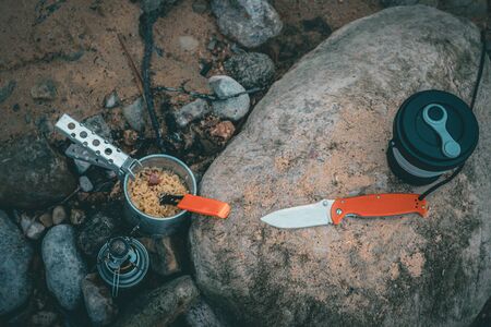 Cooking while hiking with a backpack.の写真素材