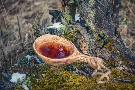 Wooden finnish cup (kuksa) with scenic backgroundの写真素材