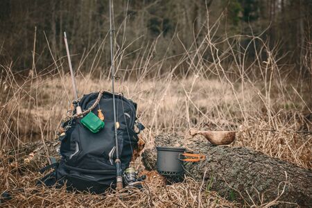 Fishing on the forest river. Cooking while hiking with a backpack.の写真素材