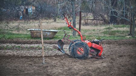 Walk-behind tractor stands on the village farm.の写真素材