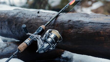 Fishing gear on the bank of a winter river.の写真素材