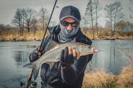 Fishing. Fisherman and trophy Asp