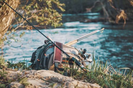 Fishing equipment on the bank of the spring river.の写真素材