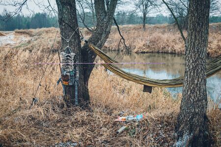 Rest during the hike. Hammock, backpack and campfire accessories.の写真素材