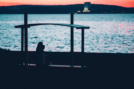 Silhouette of man and woman on a sunset background.の写真素材