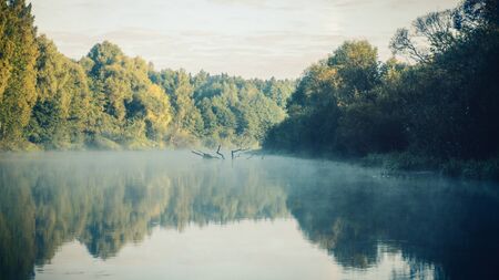 Blue sky and fog over the river.の写真素材