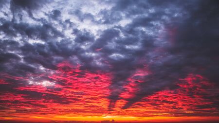 Fiery red sky at sunset. Background image.の写真素材